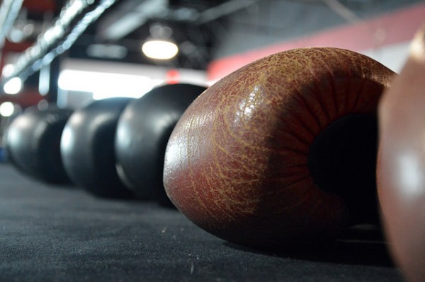 "Boxing Gloves sitting in a ring" by Aberro Creative