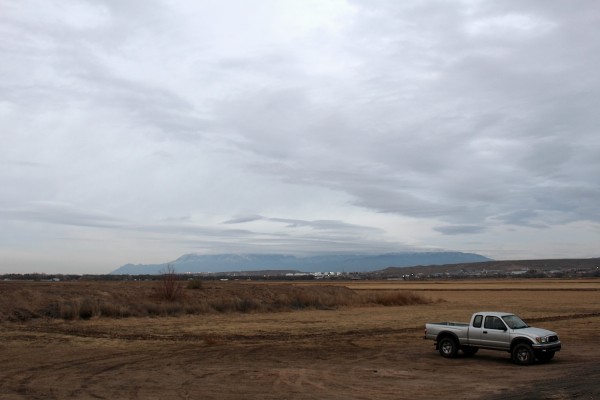 The Sandias under a dollop of clouds, from Valle de Oro.